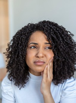 Woman experiencing toothache at home