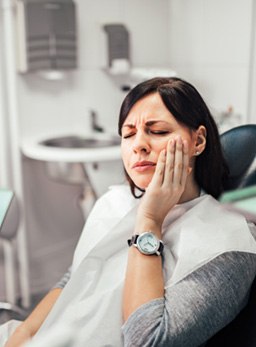 Woman with toothache in treatment room