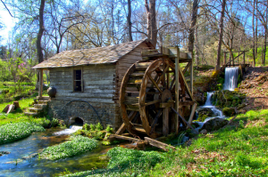 A water wheel next to a building